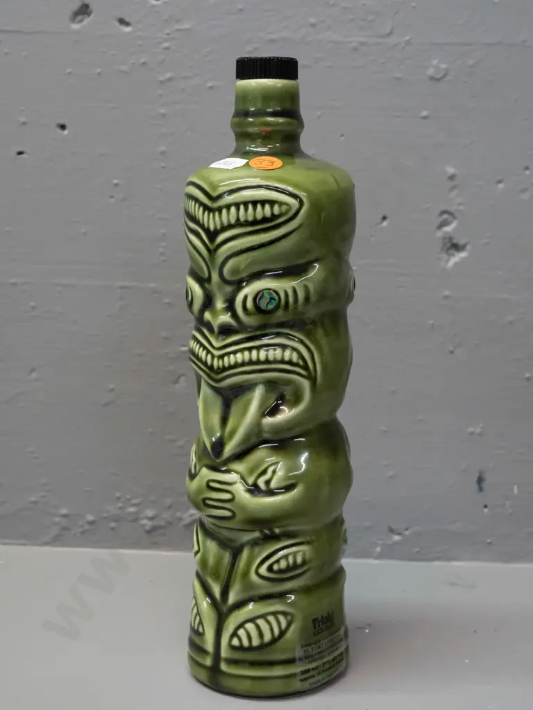ceramic tiki liqueur bottle with paua eyes, Ti-Toki Auckland label, made in Aotearo impressed on base H-290 Image 1++