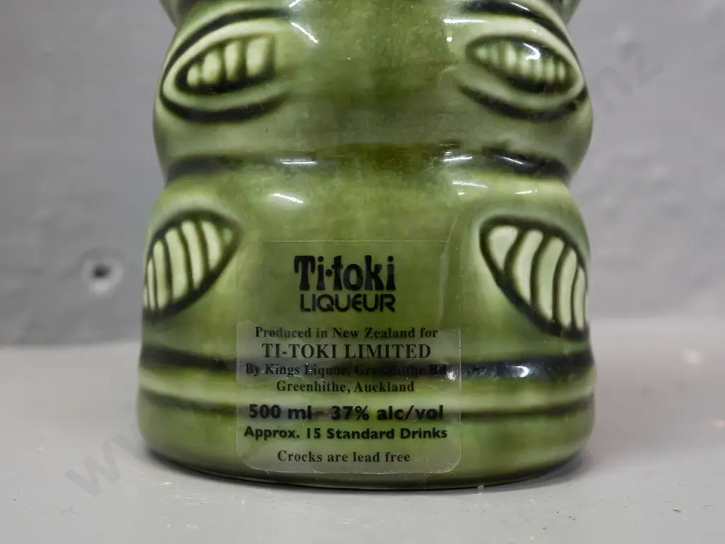 ceramic tiki liqueur bottle with paua eyes, Ti-Toki Auckland label, made in Aotearo impressed on base H-290 Image 1++