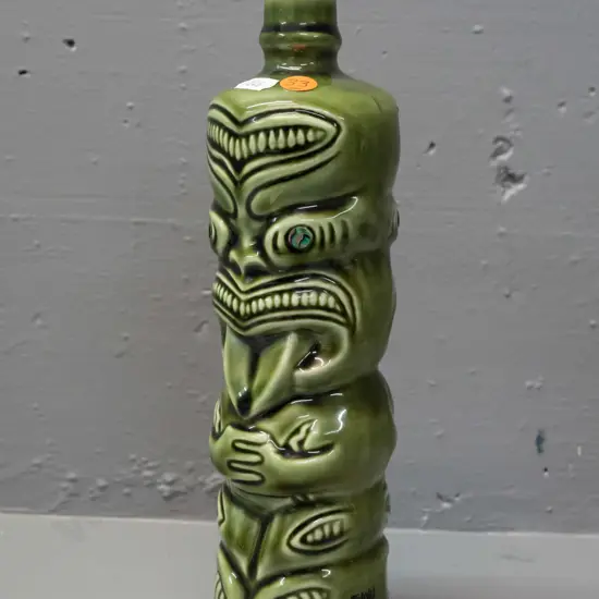ceramic tiki liqueur bottle with paua eyes, Ti-Toki Auckland label, made in Aotearo impressed on base H-290