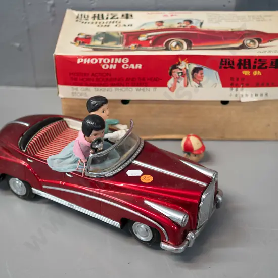 retro Chinese battery powered tin toy car with passengers, lights and sounds untested, but battery compartment is clean,