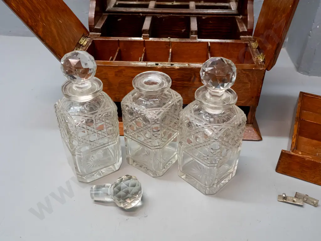 vintage oak tantalus with 3 decanters, lift-up lids exposing storage compartments, concealed latch for lower spring- Image 1++