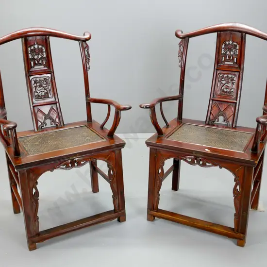 pair of Chinese elm Qing yoke-back chairs with carved back splats with flower and deer motifs, carved front bracket,