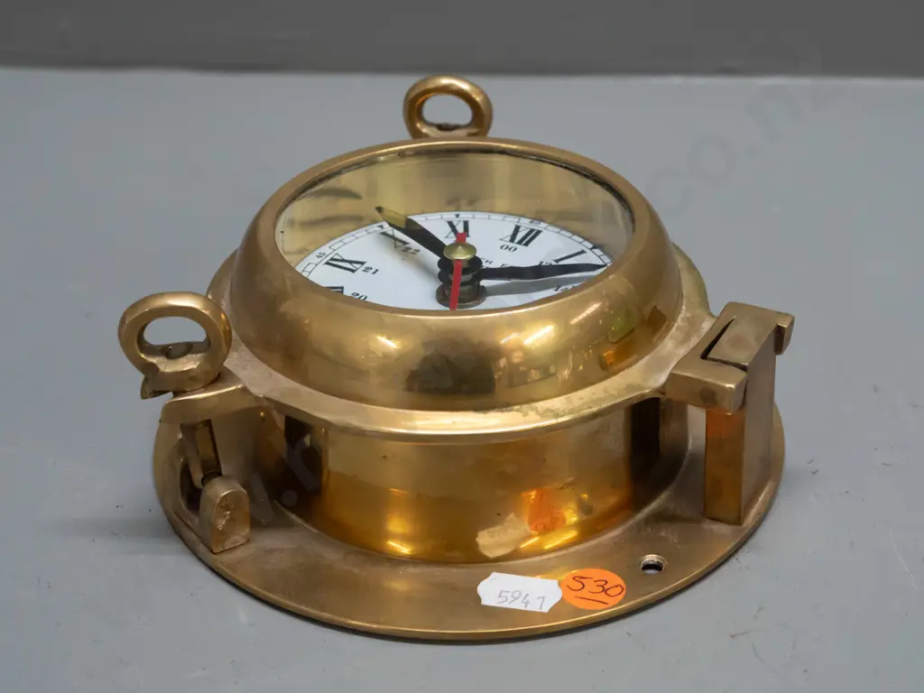 small brass porthole style clock with quartz movement - face marked Gorch Fock Hamburg, minor discolouration D-150 Going Image 1++