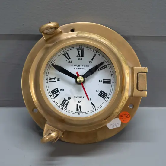 small brass porthole style clock with quartz movement - face marked Gorch Fock Hamburg, minor discolouration D-150 Going