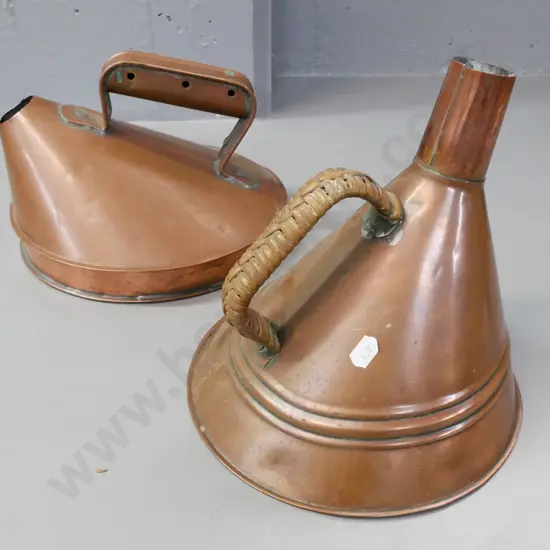 2x coppered white metal conical-shaped kettles, one with woven cane handle. Some dinting and corrosion.