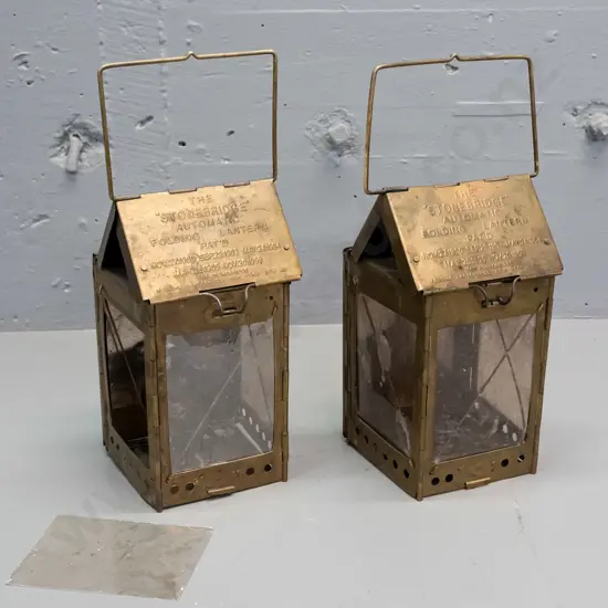 2 vintage brass folding candle lanterns marked Stonebridge Automatic Folding Lantern NYC, one with loose mica panel.