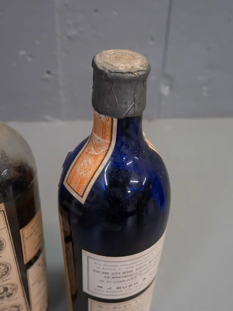 3 vintage glass bottles with labels and contents & WJ Bush & Co labels, one blue & 2 clear, metal cap seals H-250 Image 1++