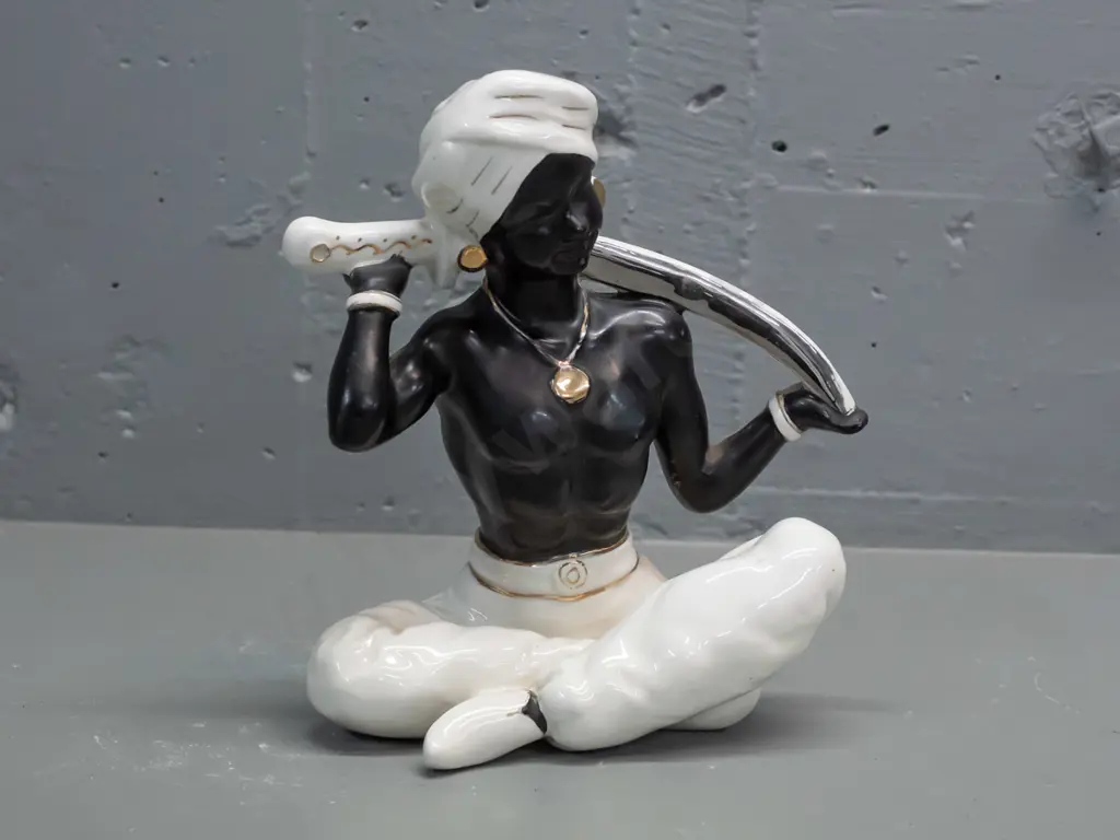 retro porcelain seated genie figure, black and white with gilt and silver, no maker's mark - some rubbing to gilt H-230 Image 1++