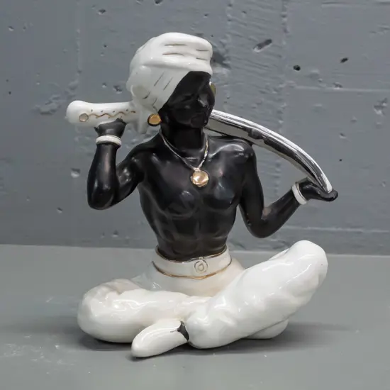 retro porcelain seated genie figure, black and white with gilt and silver, no maker's mark - some rubbing to gilt H-230