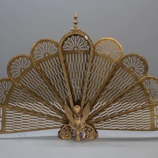 brass folding fan fire screen with mythical winged animal at base - split to one fan section, some overall pitting H-630