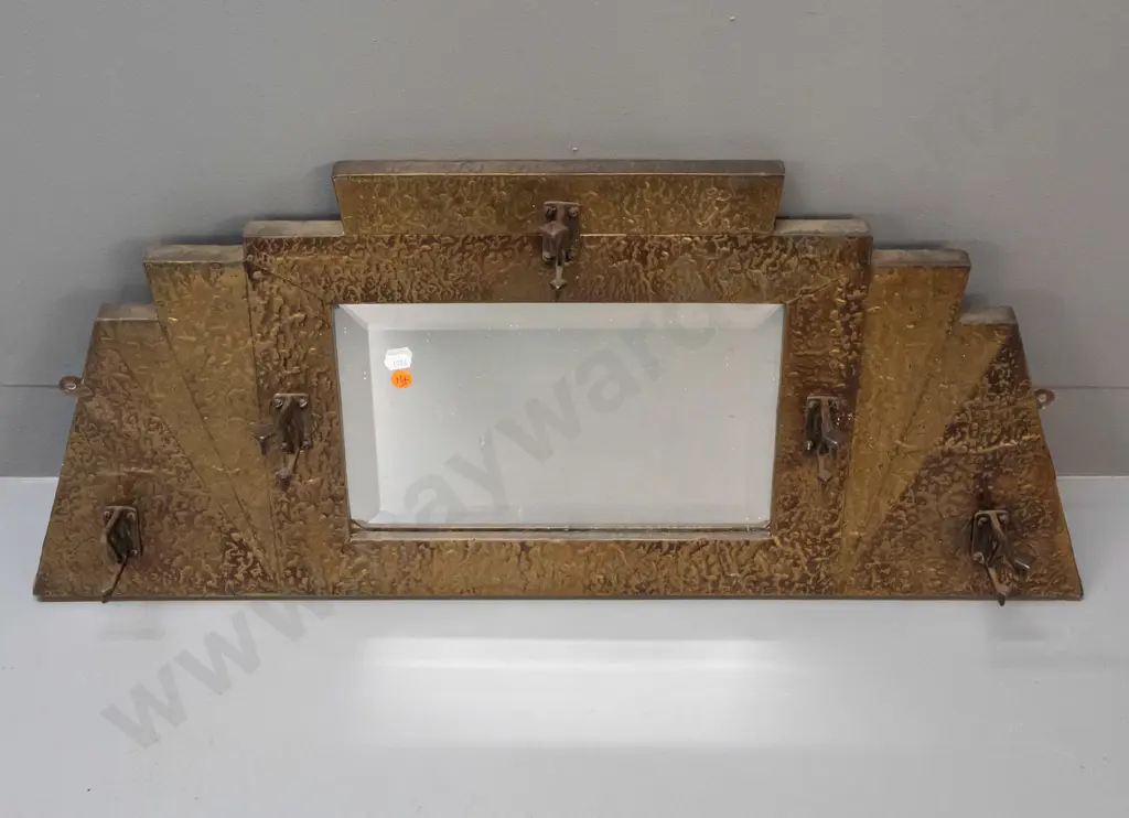 art deco beaten brass bevelled edge wall mirror with 5 hat / coat hooks. Tip broken off one hook, some desilvering. Image 1++