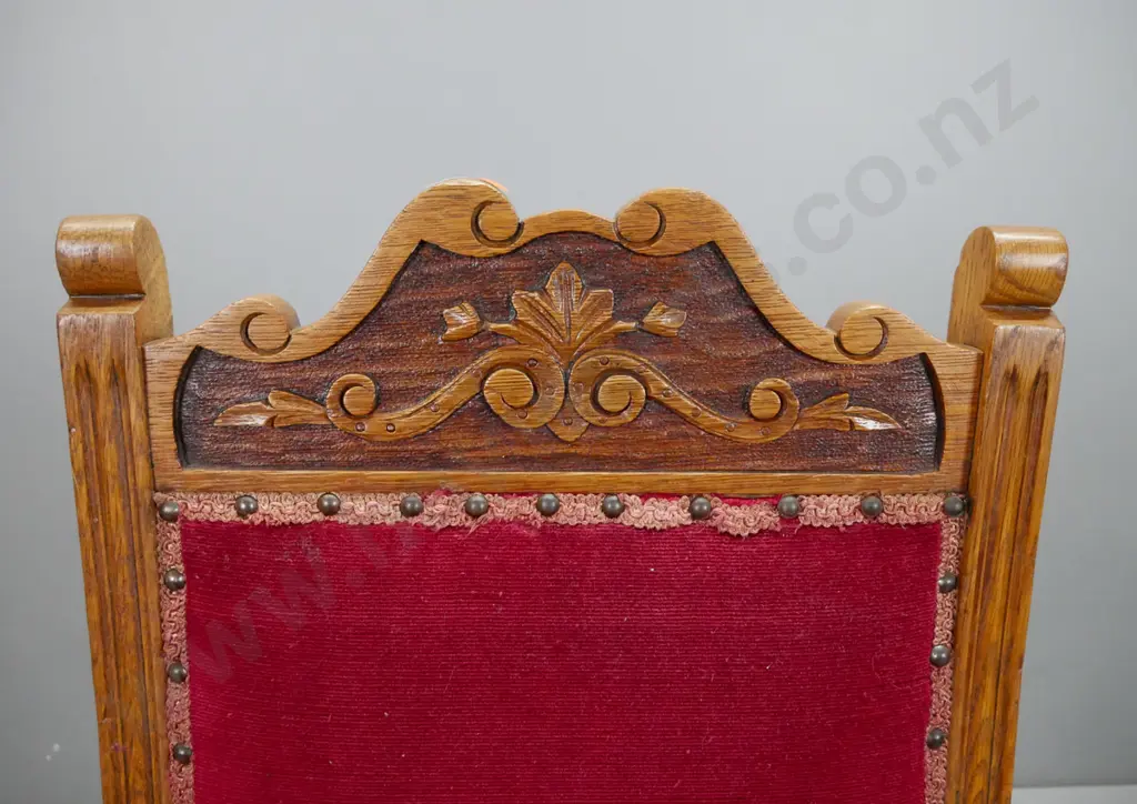 Victorian oak bedroom chair with carved foliate back, studded red fabric back and seat, turned front legs, on metal Image 1++