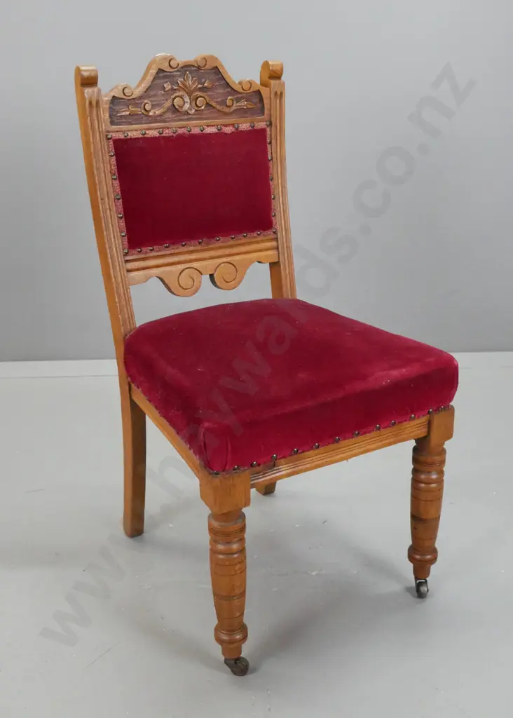 Victorian oak bedroom chair with carved foliate back, studded red fabric back and seat, turned front legs, on metal Image 1++