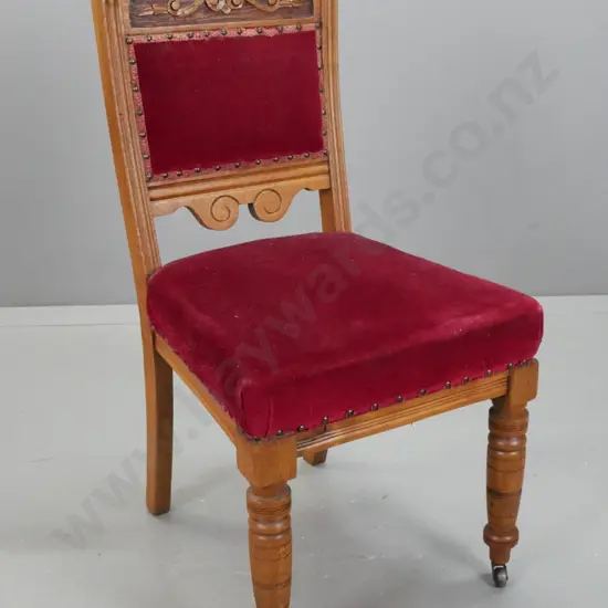Victorian oak bedroom chair with carved foliate back, studded red fabric back and seat, turned front legs, on metal