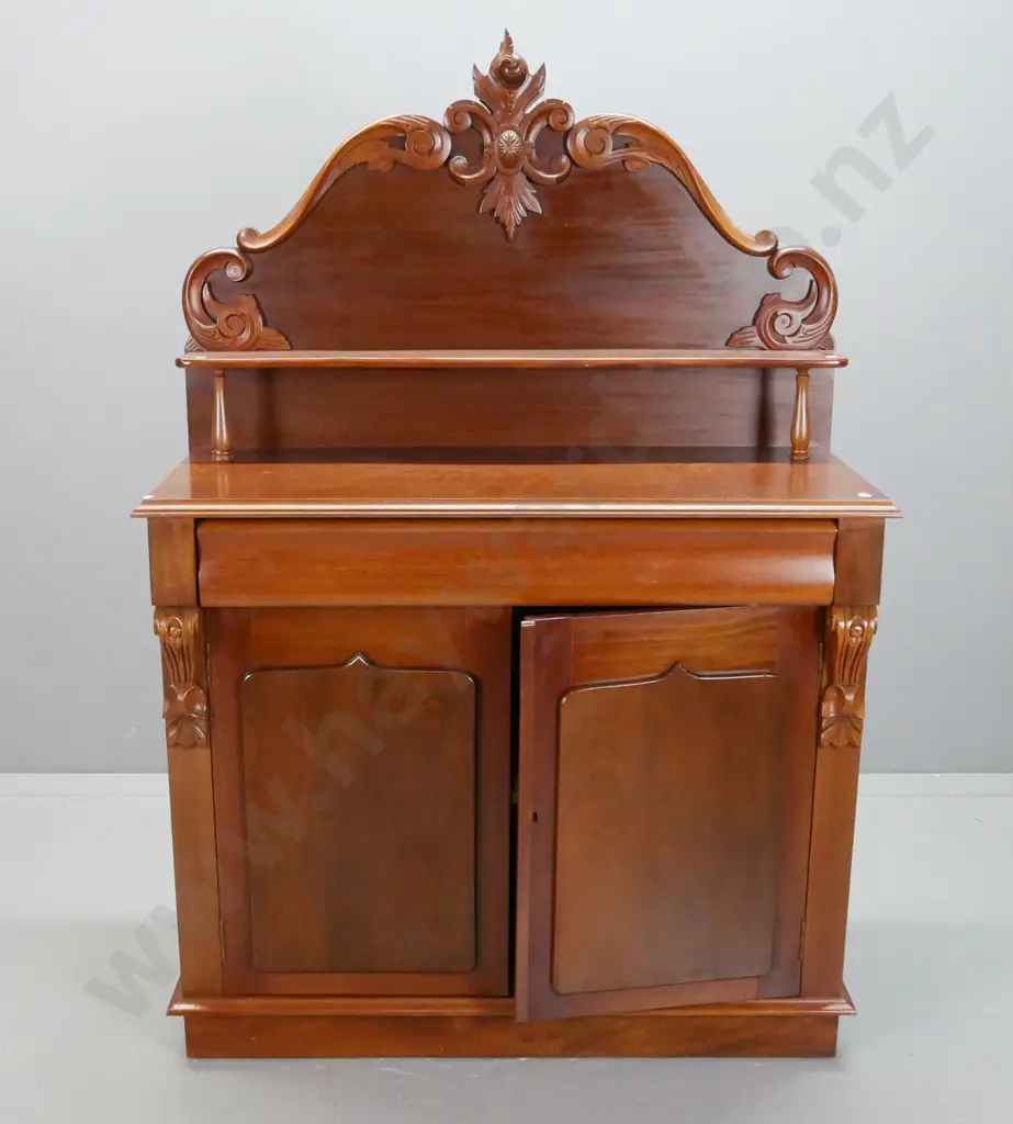 reproduction mahogany carved-back chiffonier with long top drawer and 2 panelled shield doors, upper shelf on turned Image 1++