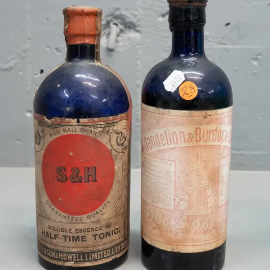 2 vintage cobalt blue bottles with labels and contents - Duckworth & Co Dandelion & Burdock stout & Stevenson & Howell