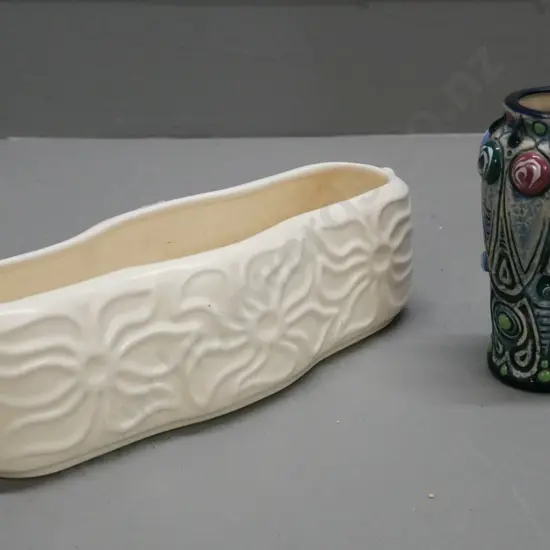 Crown Lynn trough with moulded floral decoration. Heavily crazed, chip to bottom rim, cracks to top rim..