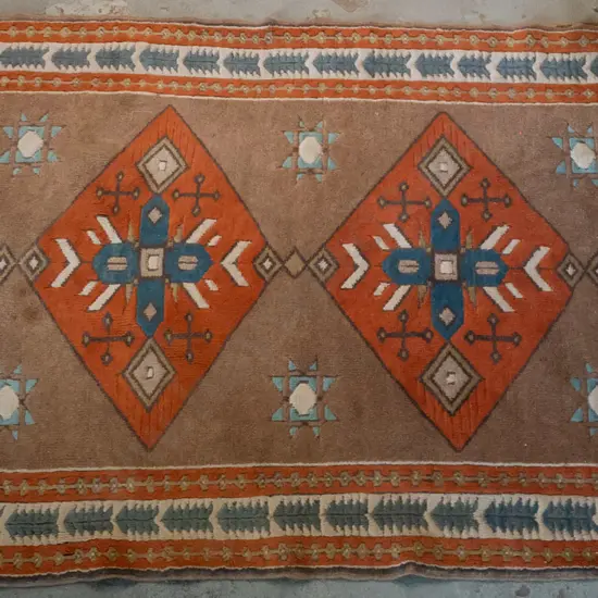 hand knotted wool floor rug in blue, orange, cream and brown geometric patterns - wear to fringe, staining L-1640