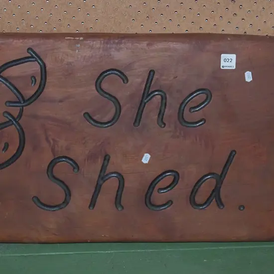 carved wooden She Shed sign