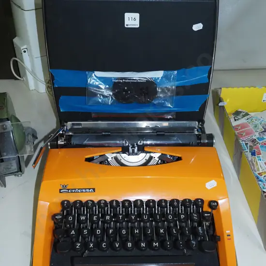 retro orange plastic Contessa typewriter with additional ribbon