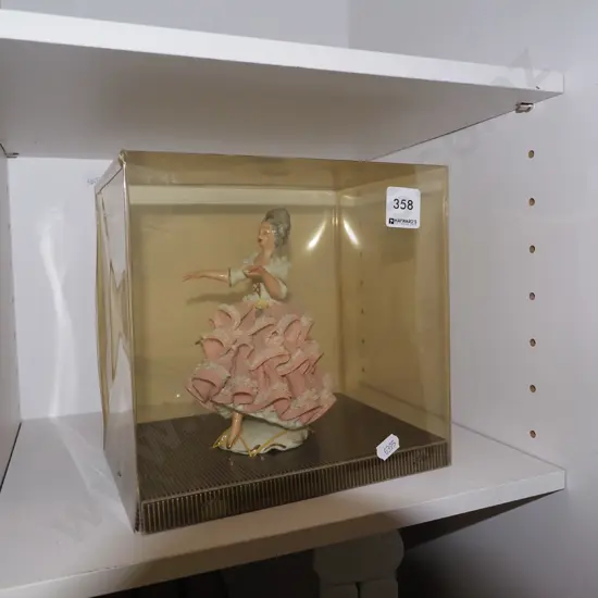 cased female figurine 