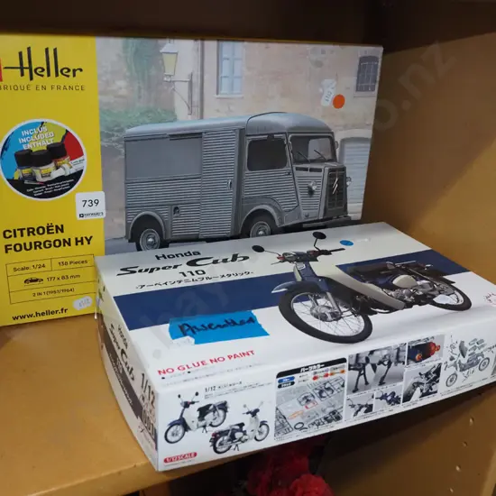 yet to be assembled Citroen van, assembled model of a Honda Supercub motorcycle