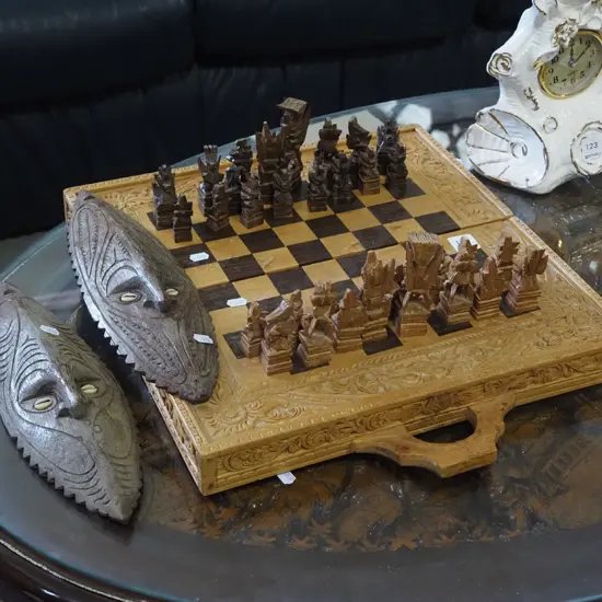heavily carved Indonesian chess board, 2x ethnic masks