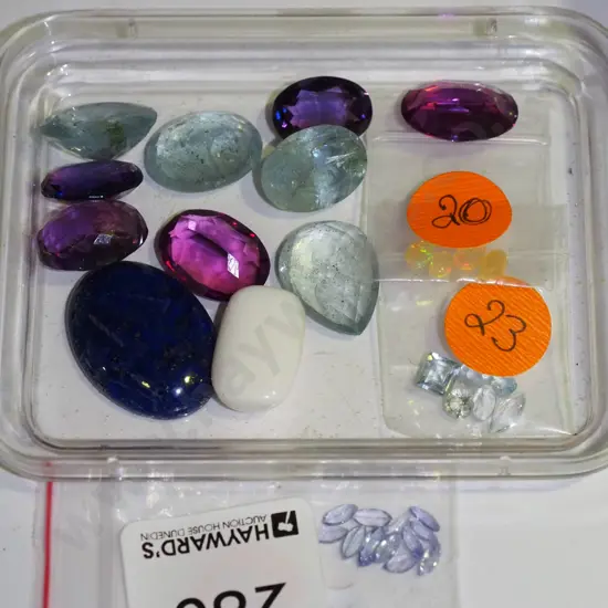 small tray of various cut and polished gemstones