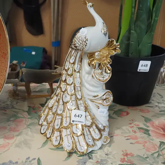 white and gold peacock figurine