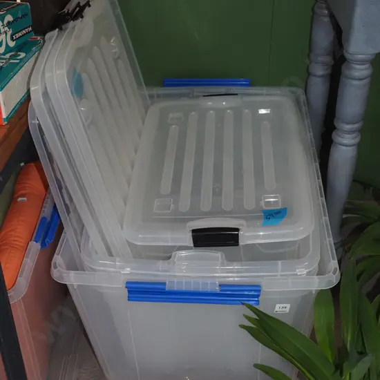 various lidded white plastic storage bins