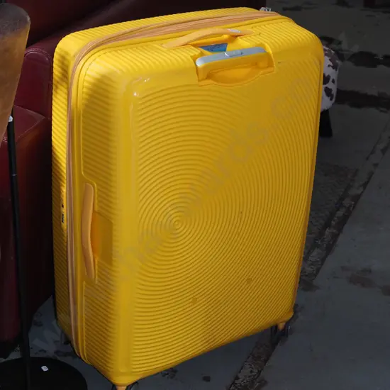 large yellow American Tourister suitcase