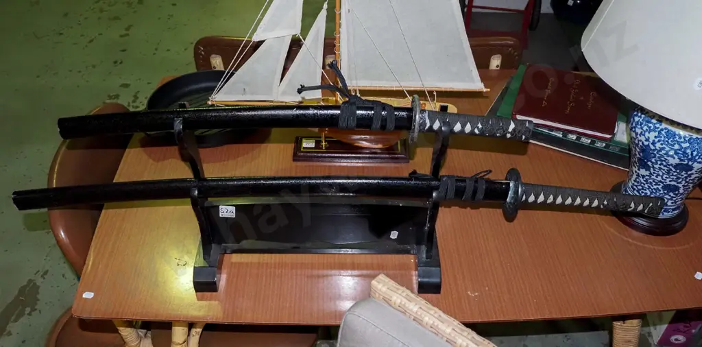 pair of Japanese swords on stand Image 1++