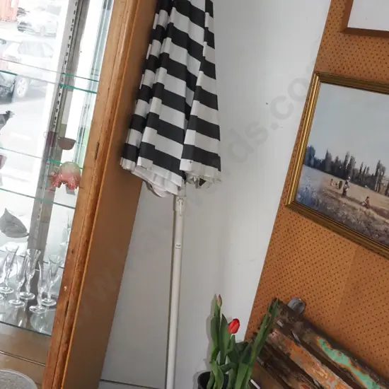 green and white umbrella with stand - umbrella too small for stand