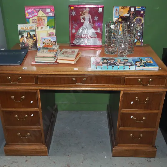 restorer's mahogany veneer  9 drawer desk with tooled leather inset - some damage to veneer