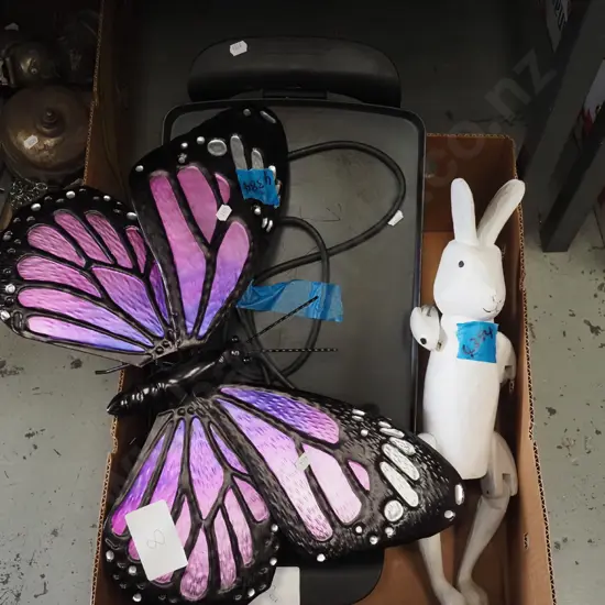 box; large electric griddle, wooden toy rabbit, butterfly wall art