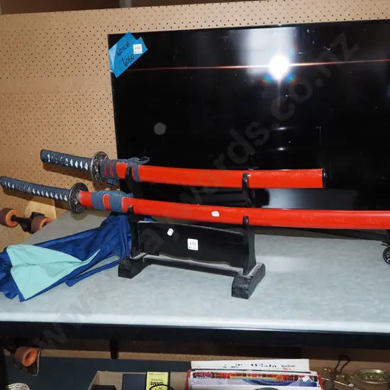 2x Japanese decorative swords with stands and blue fabric protective bags