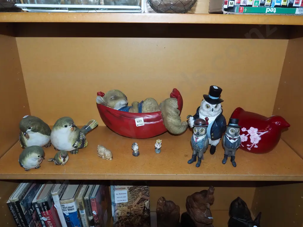 shelf of composite and ceramic animal figurines Image 1++