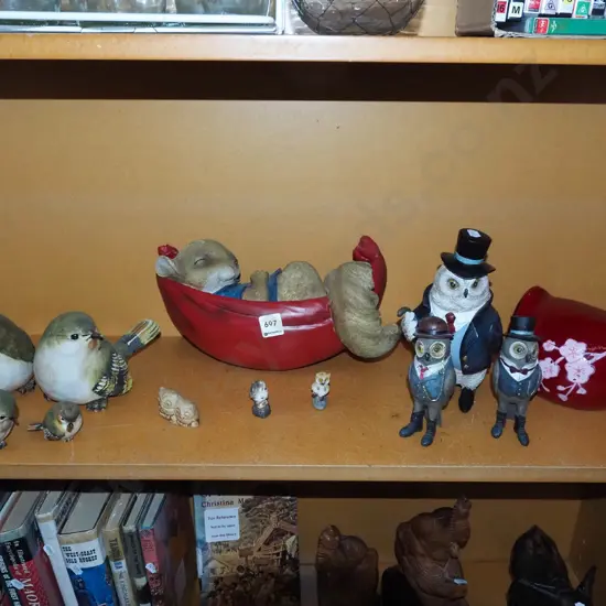 shelf of composite and ceramic animal figurines