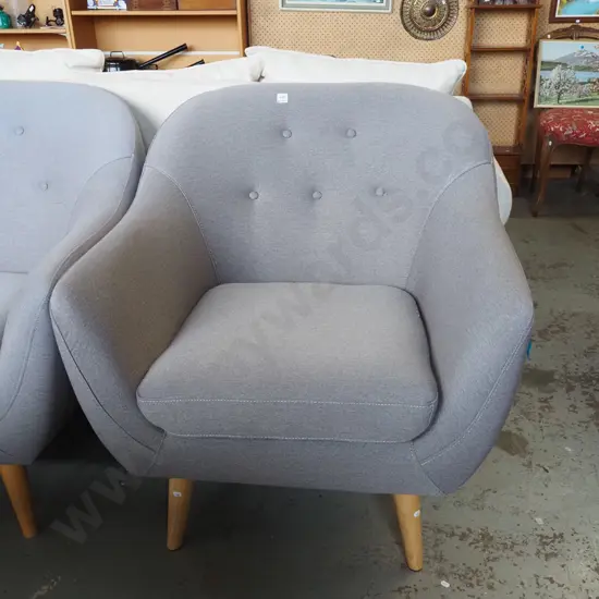 contemporary grey upholstered deep buttoned armchair