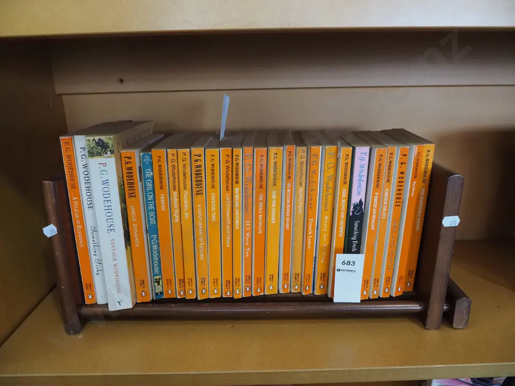 various PG Wodehouse books on a small wooden bookcase Image 1++