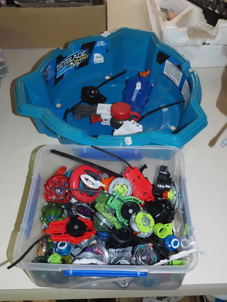 plastic container of Beyblades and a tournament container Image 1++