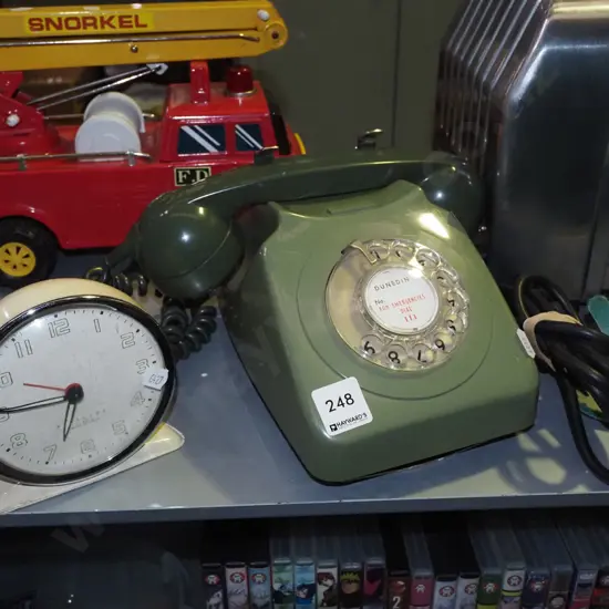 green plastic dial telephone, wind up clock