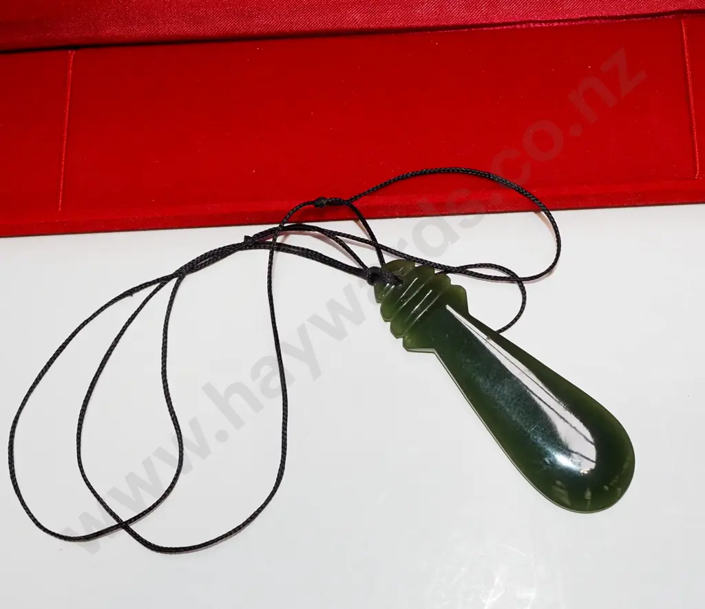 pounamu on cord in case Image 1++