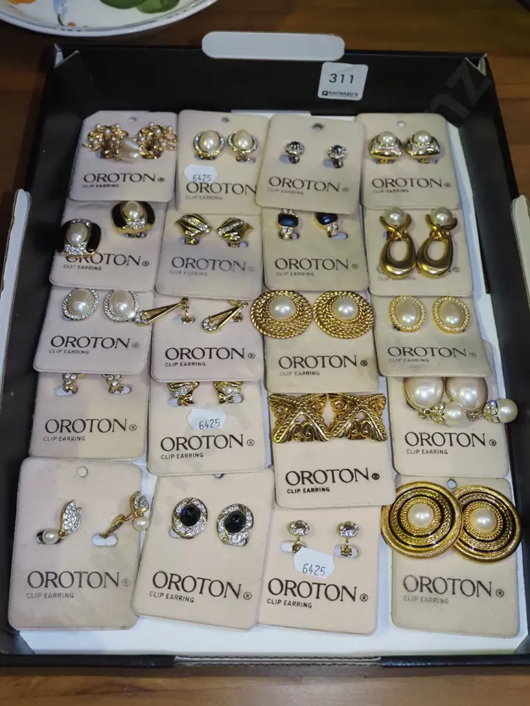 box of Oroton clip on earrings Image 1++