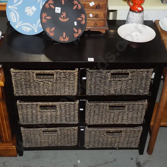 dark stained wooden cabinet with 6 seagrass basket drawers