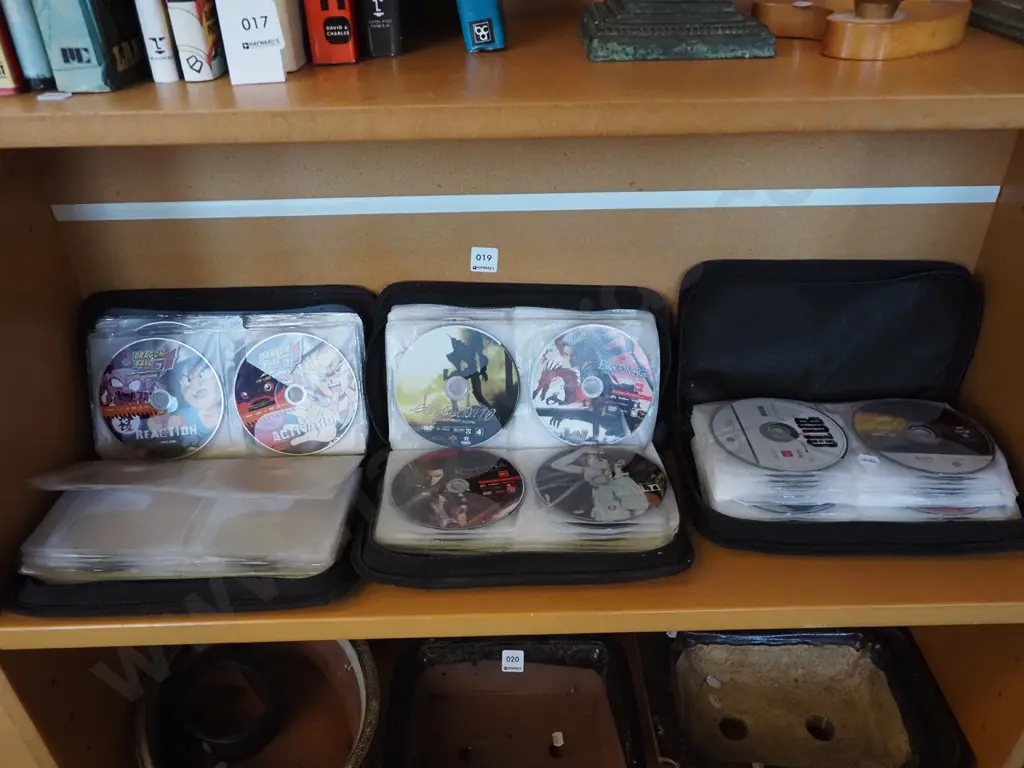 3x pouches of anime movies, x box games etc Image 1++