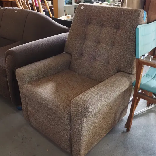 brown upholstered deep buttoned reclining armchair