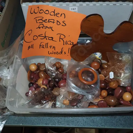 plastic tub of wooden beads from trees in Costa Rica