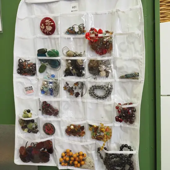 costume jewellery in coat hanger holder