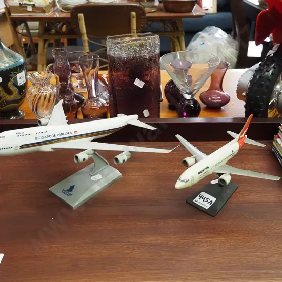 2x plastic airline models on stands - Qantus and Singapore Airlines